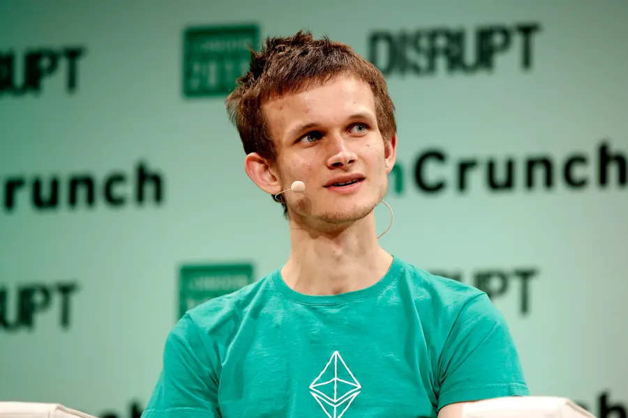 Vitalik Buterin, creator of Ethereum, at a tech event, discussing the origins of Ethereum from an idea to a revolutionary blockchain platform.